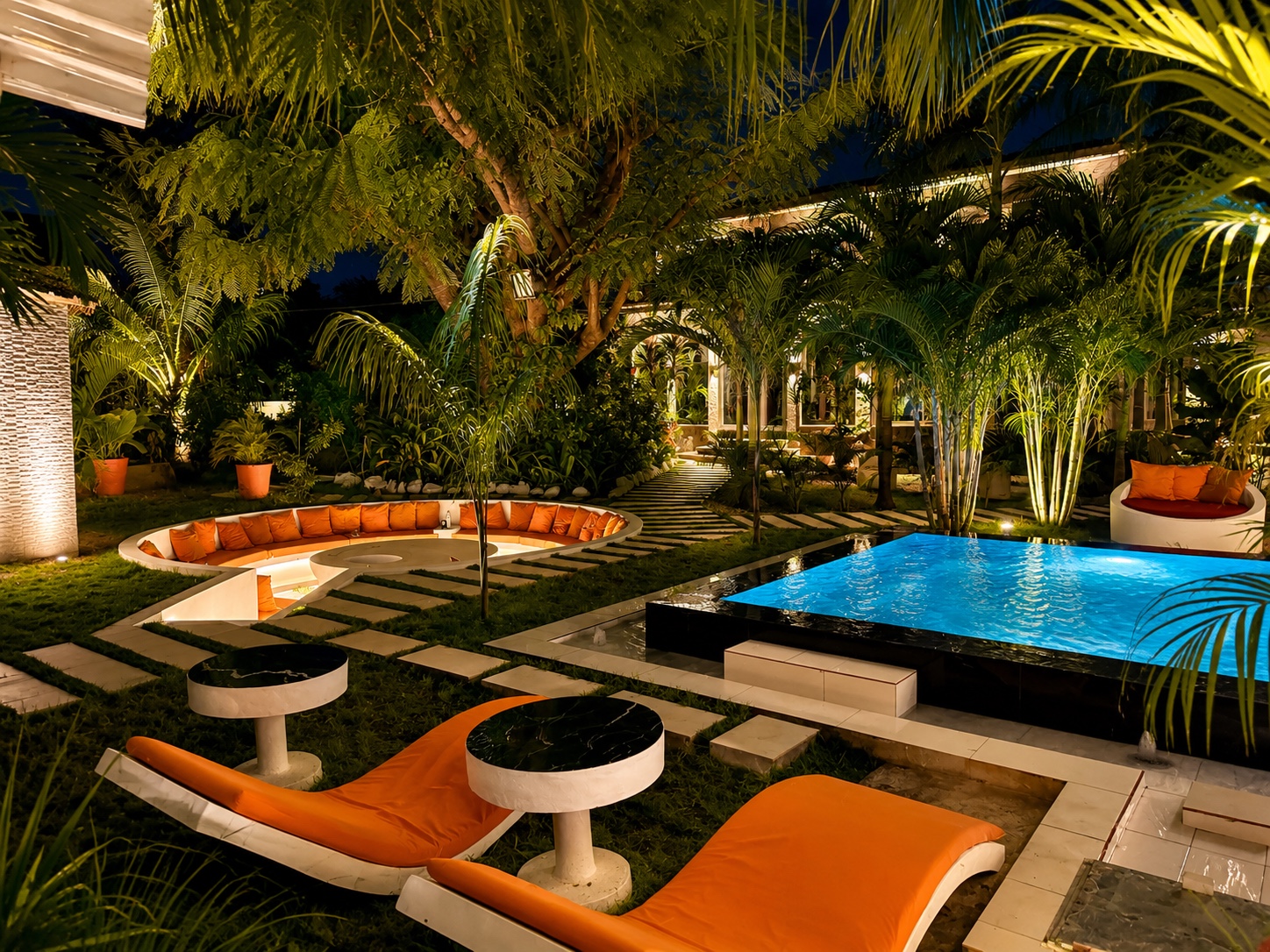 Sunken lounge and plunge pool illuminated in the garden at night