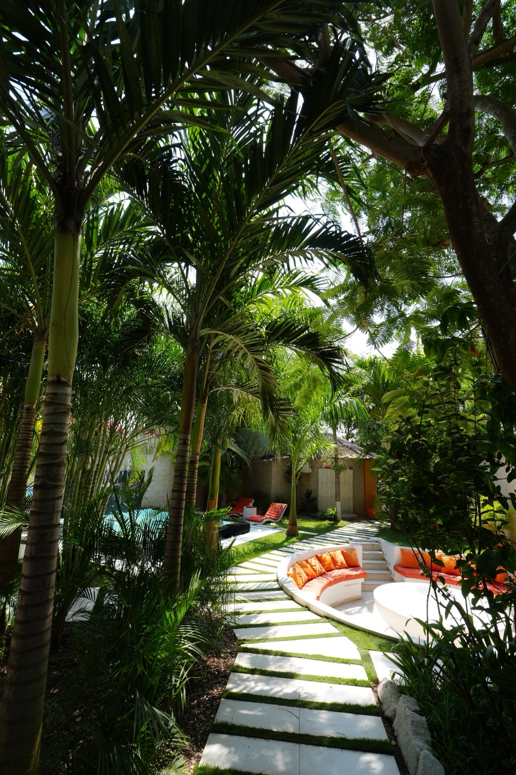 Palm-lined garden path leading to the sunken lounge
